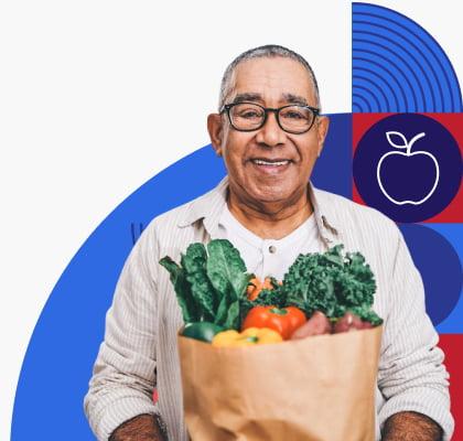 A man holding a paper bag filled with vegetables.