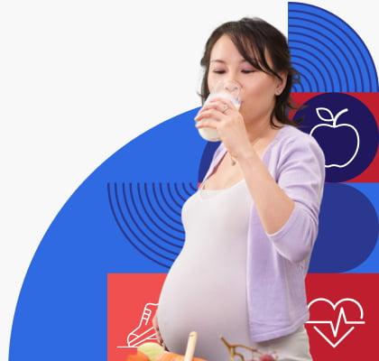 A pregnant woman drinks a glass of milk.