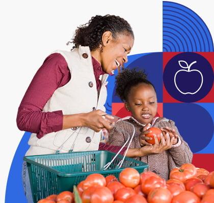 A woman and child look at tomatoes while shopping.
