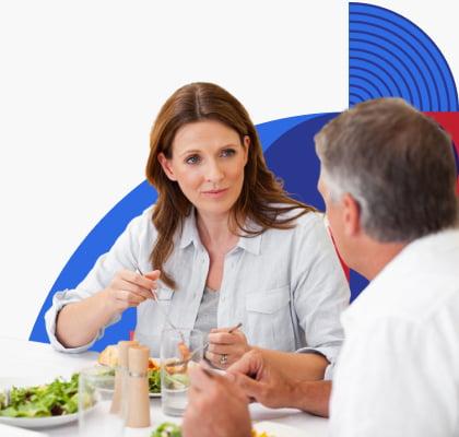 Two people sitting and eating together.