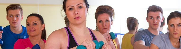 Six people use small weights in an exercise class. 
