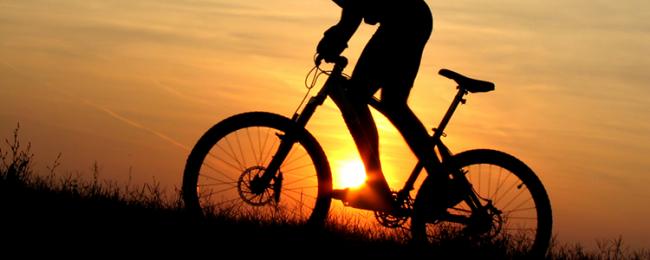 Silhouette of cyclist in sunset
